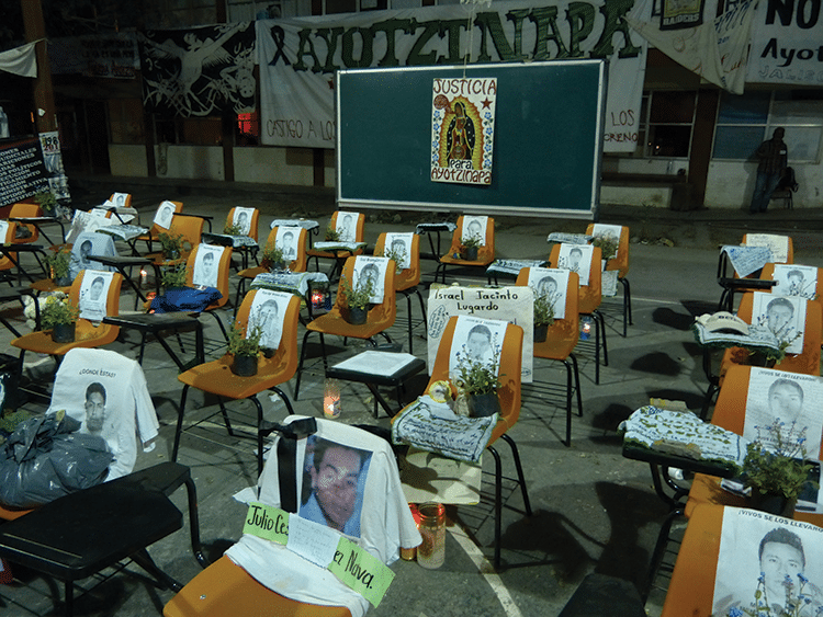 Students' images adorn school seats. Many parents believe their children are still alive, working on narcotics plantations. Photo: Témoris Grecko