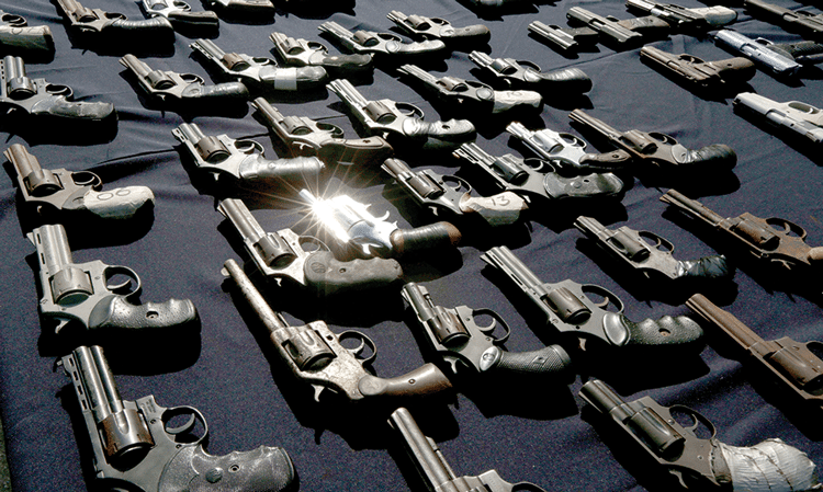 Pistols are displayed by police before their destruction in Panama City, on 6th August 2014. Photo: Arnulfo Franco/AP/Press Association Images