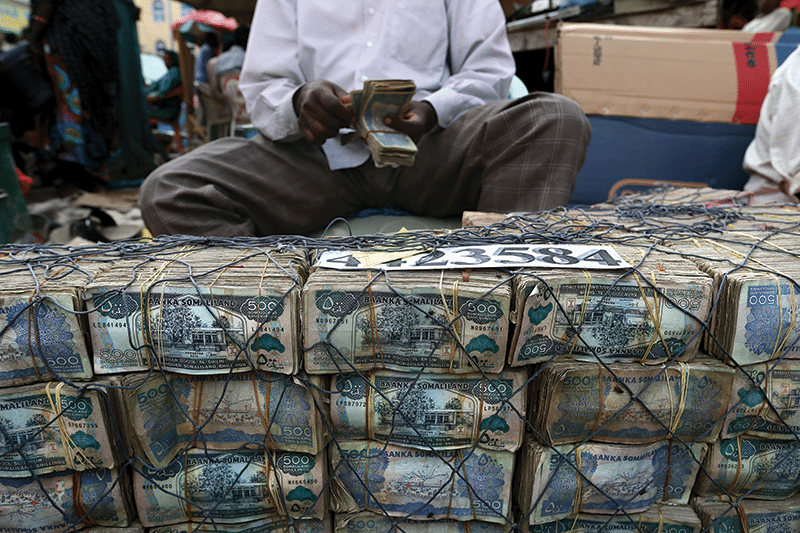 Cash from khat sales is brought to money changers and exchanged for Ethiopian birr to buy the next day's supply