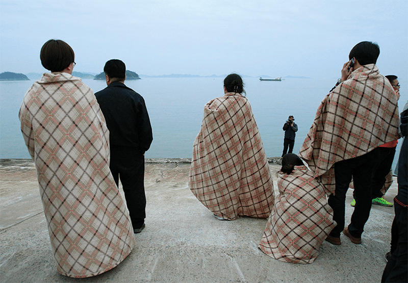 Relatives wait for their missing loved ones at a port in Jindo, South Korea, Wednesday, April 16, 2014. Photo: Ahn Young-joon/AP/Press Association Images