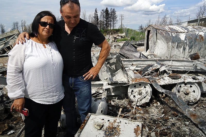 Stephanie and Blair Doucet survey what remains of their home after the fire