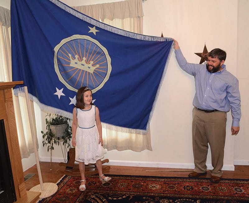 Jeremiah Heaton and his daughter Emily stand alongside their homemade blue flag. Photo: David Crigger/AP/Press Association Images
