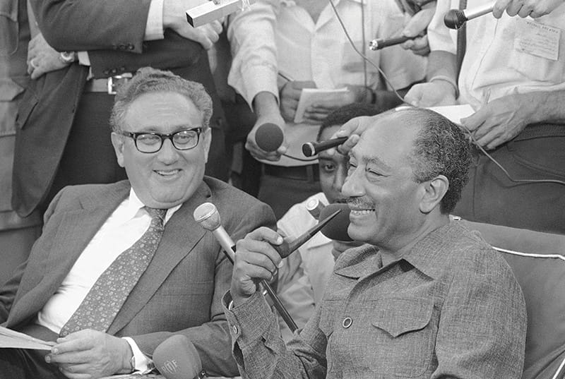 Kissinger and Egyptian president Anwar Sadat with reporters in Alexandria, 1975. Photo: AP/Press Association Images