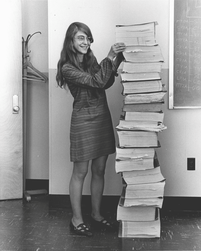 Margaret Hamilton standing next to the navigation software she and her MIT team produced for Project Apollo.  Photo: Draper Laboratory