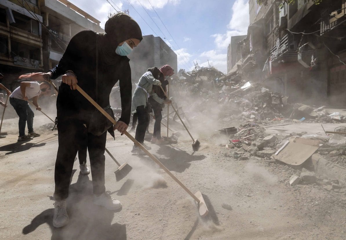Palestinian volunteers help clear rubble caused by Israeli airstrikes in the Al-Remal district of Gaza City, 23rd May 2021
