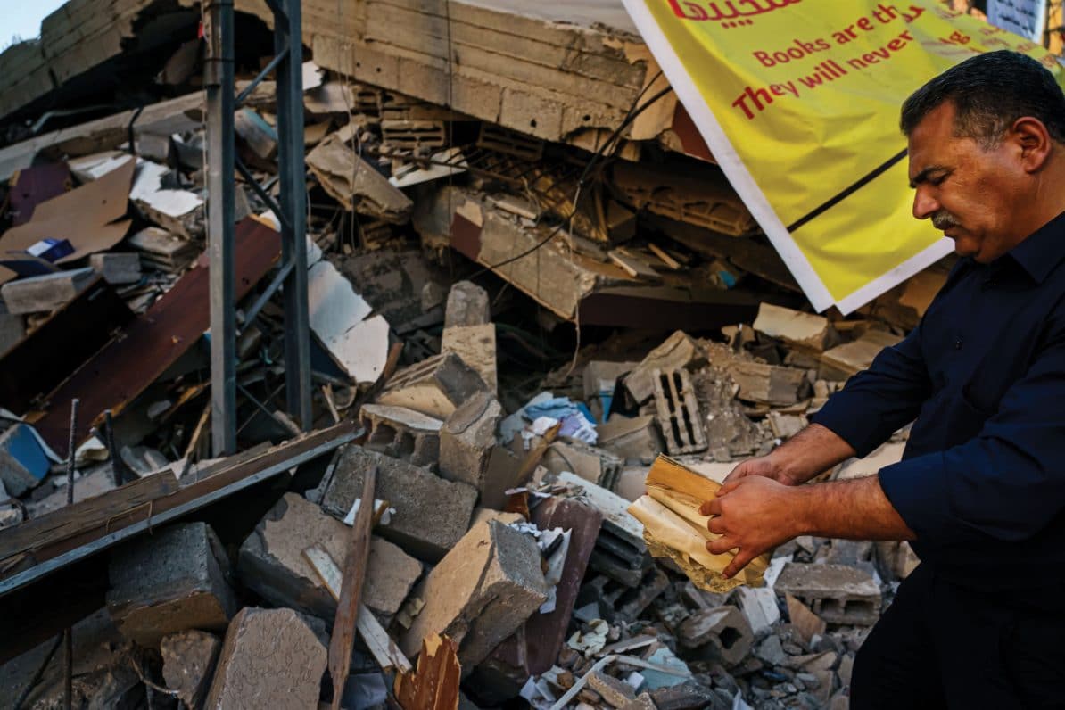 Samir Mansour stands next to his destroyed bookshop in Gaza, 26th May 2021