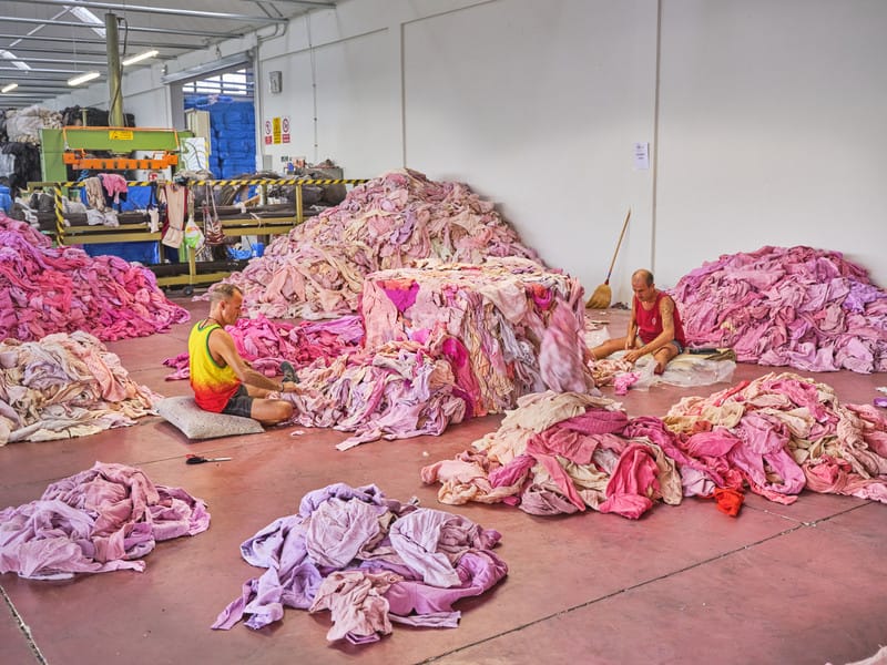 Workers sort textiles by colour in Prato, Italy. Some warehouses hold materials in colours that have been out of fashion for more than 40 years, waiting for the market to want them again