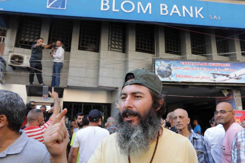 Bassam al-Sheikh Hussein, who stormed a bank to demand access to his savings on 11th August 2022, appears outside a Beirut branch of Blom Bank on 16th September to lend his support to one of the seven bank ‘robberies’ to take place that day 