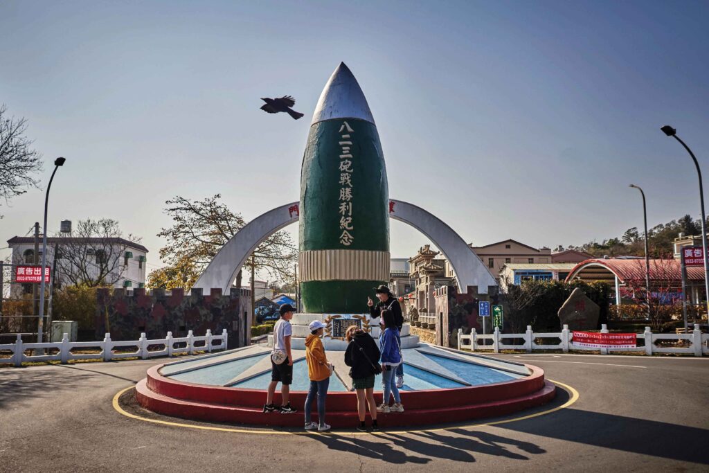 Tourists stand at the base of a memorial that commemorates the 1958 Second Taiwan Strait Crisis in Lieyu, one of the Kinmen islands
