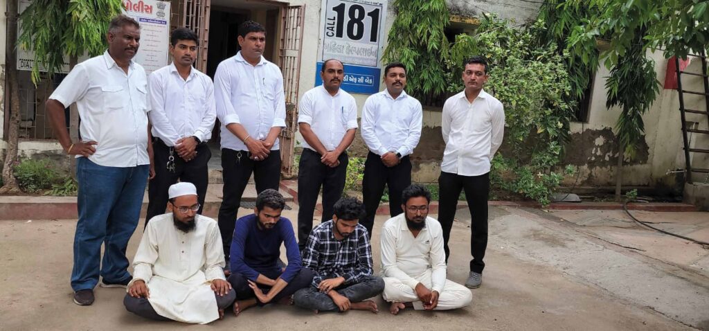 Police officers in Mehsana stand over Mohammed Kolu, Shoeb Davda, Sadiq Davda and Saqib Mahamad, the four people arrested in connection with organising the fake tournament
