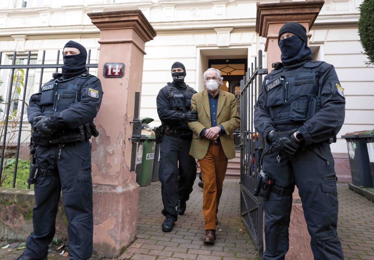 Masked officers lead Heinrich XIII Prince Reuss, one of the alleged leaders of the ‘Reichsbürger’ movement, to a police vehicle in Frankfurt on 7th December 2022