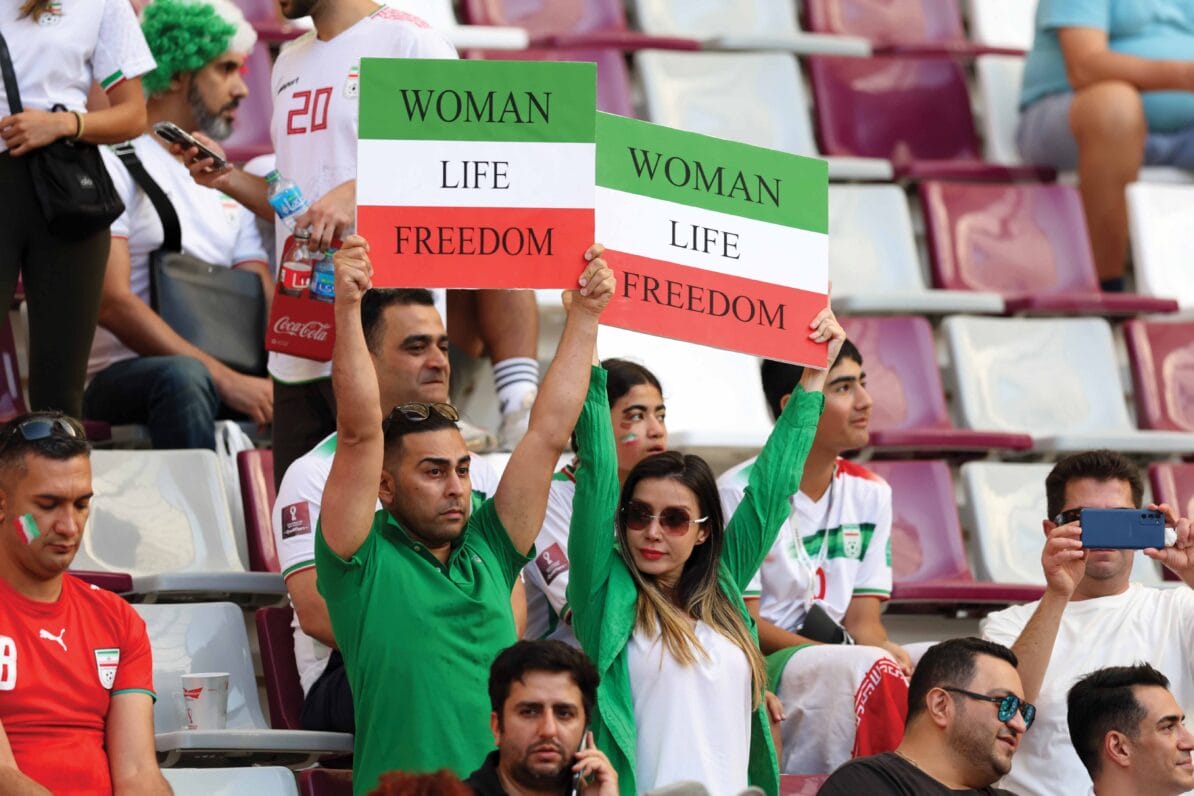 Iranian fans hold up signs advocating for women’s rights prior to the World Cup match between England and Iran on 21st November 2022