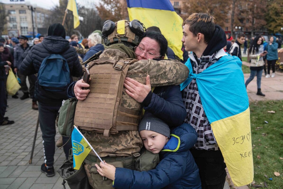 Local residents hug a Ukrainian soldier as they celebrate the liberation of Kherson, 13th November 2022